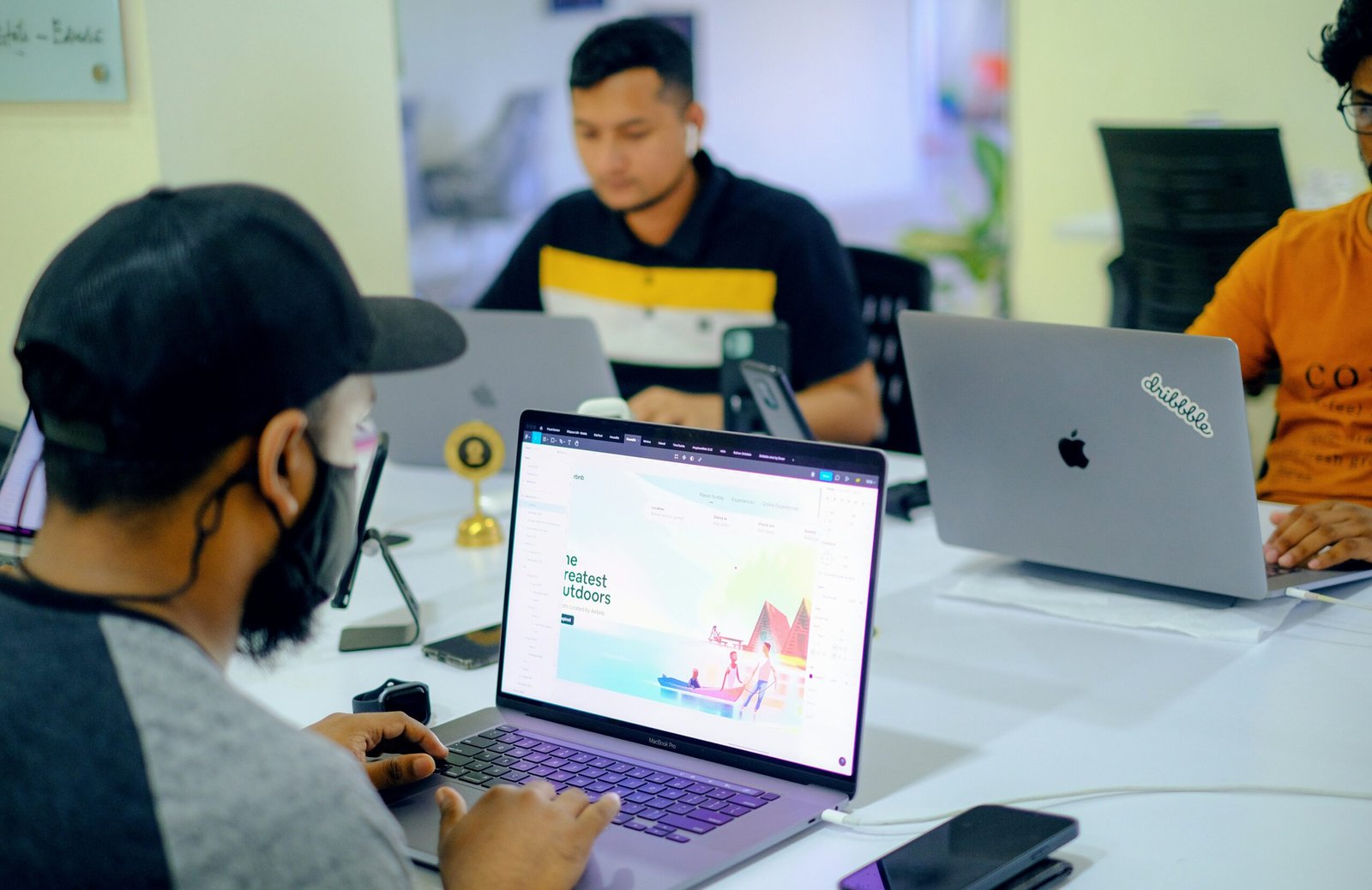 man in gray jacket using macbook pro Web Developer image